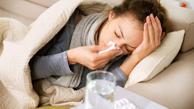Sick Woman. Flu. Woman Caught Cold. Sneezing into Tissue